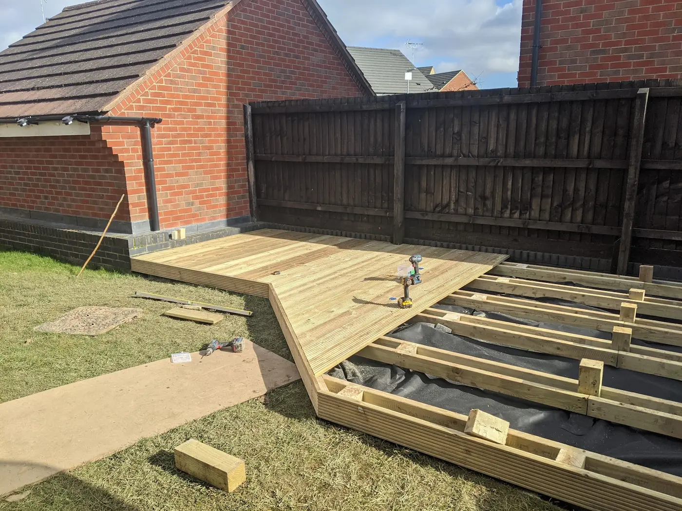 New deck boards being fixed over a new, evenly spaced joist frame