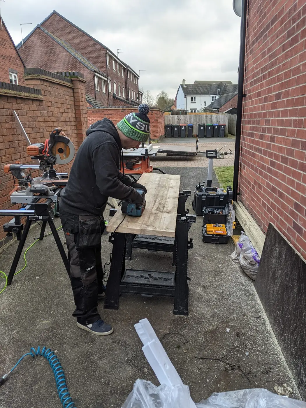 An AA Bespoke joiner cutting timber on site